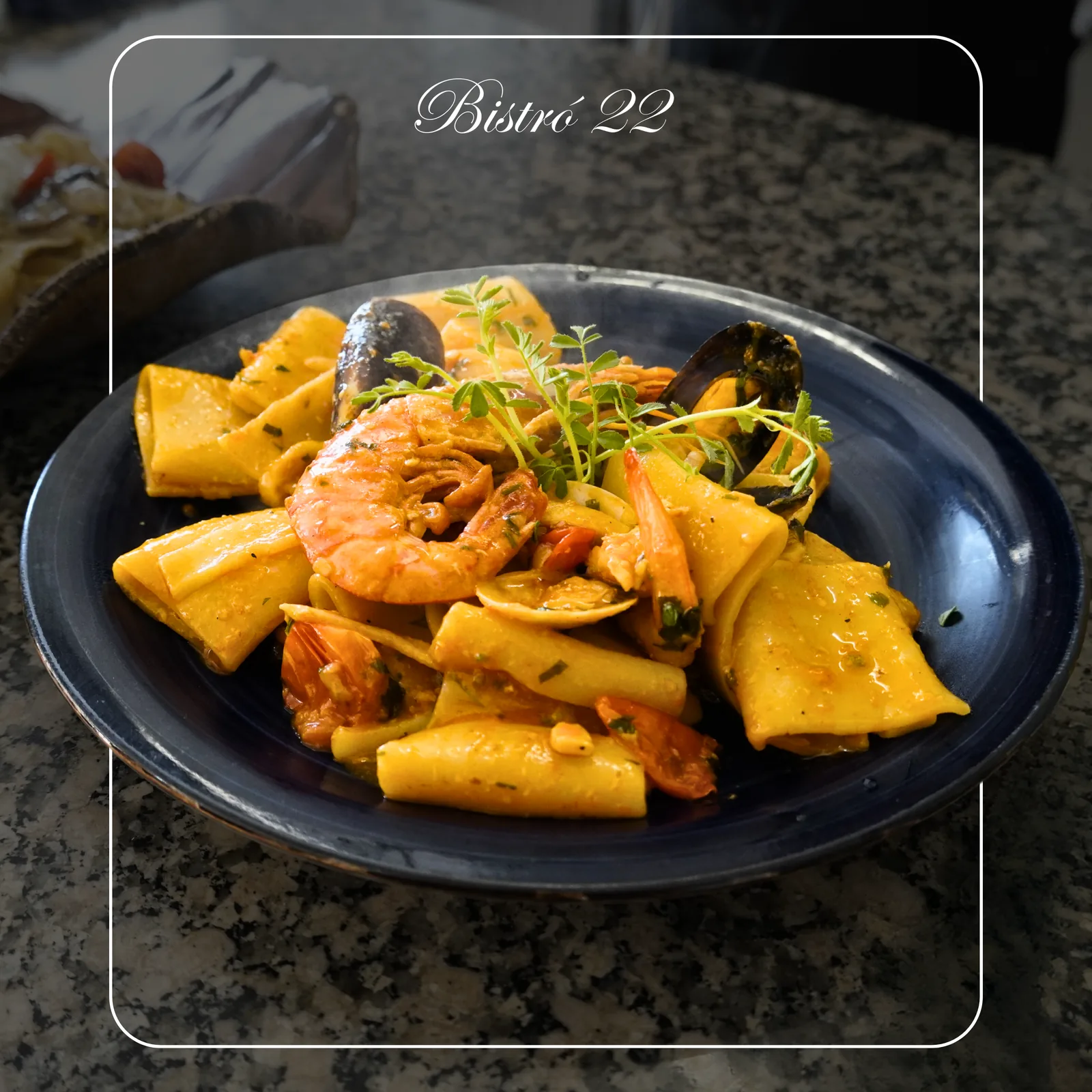 Paccheri with prawns on a blue plate, menu photography